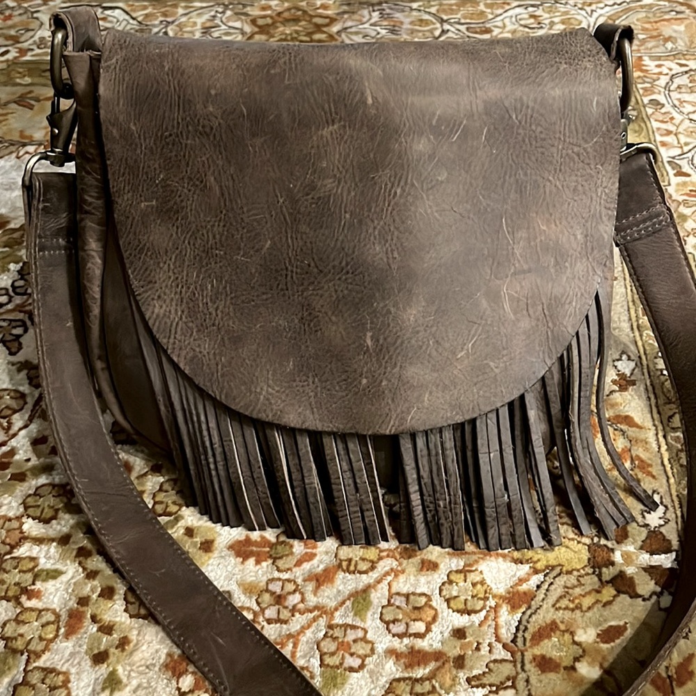 Crossbody leather messenger bag with fringe detail
